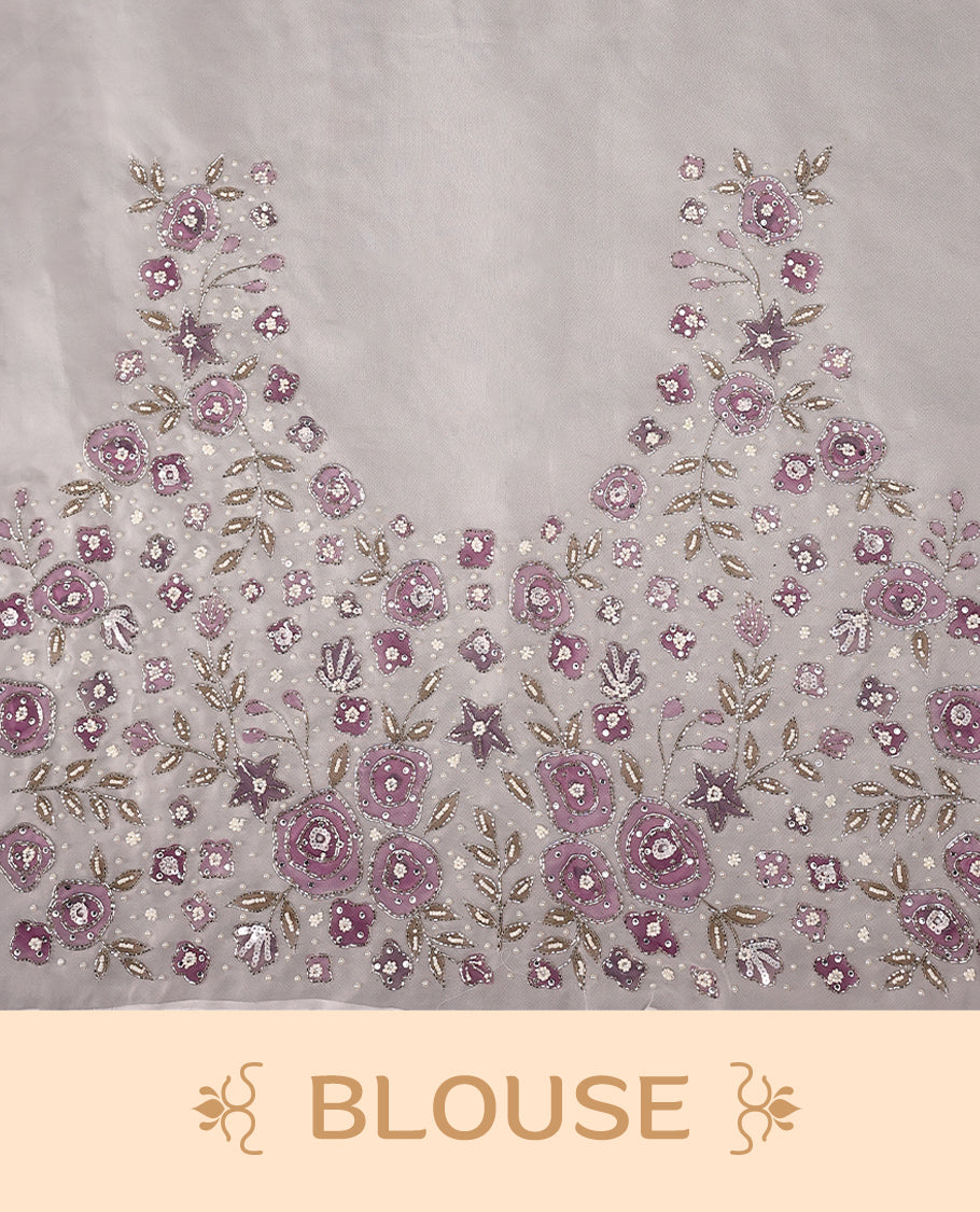 White colour pure organza saree featuring Grape Colour floral prints with intricate bead and sequin work across the body, adorned with a matching embellished border, complemented by a worked pallu and paired with a heavily worked matching blouse.