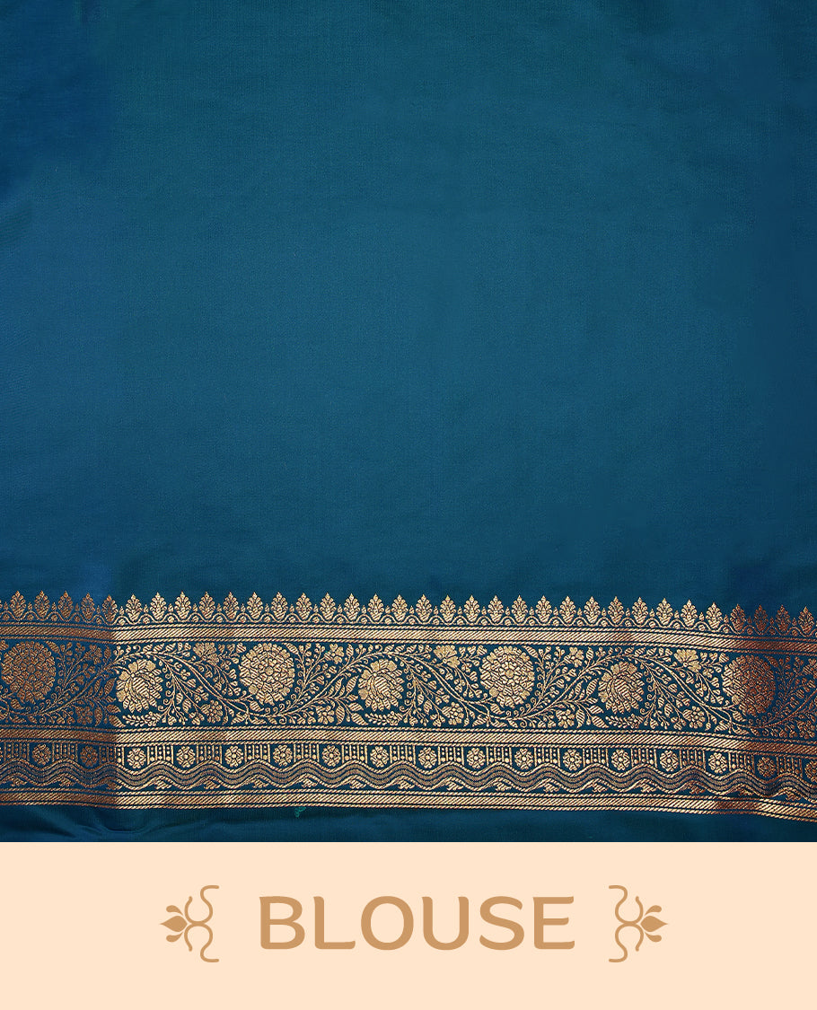 Peacock blue colour semi Banaras satin crepe saree featuring gold zari woven floral motifs across the body, complemented by an intricately designed traditional banarasi border and richly woven pallu, paired with a matching blouse piece.