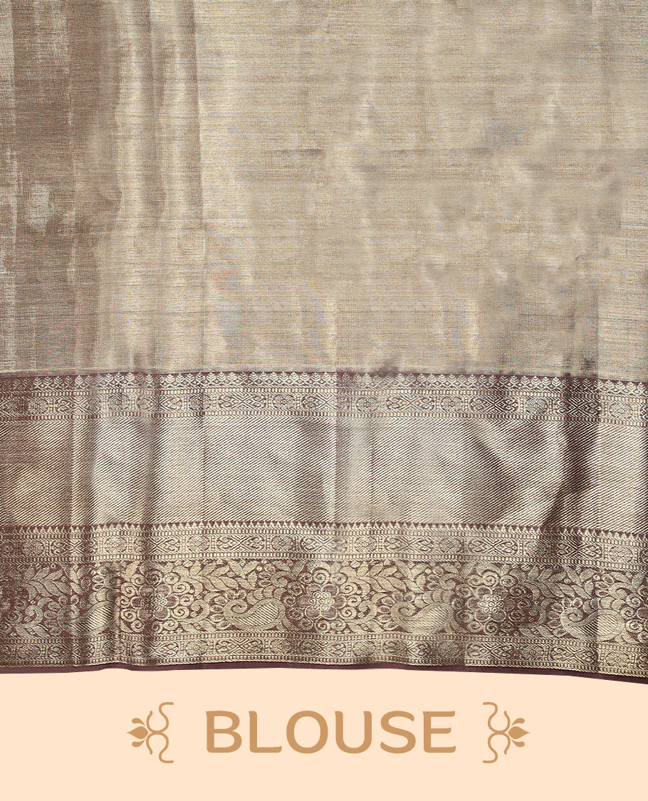 Pastel brown Colour Kancheepuram tissue silk saree adorned with intricate silver and pastel brown Zari floral motifs on the body, gracefully complemented by a traditional mango and floral design border, and paired with a matching blouse.