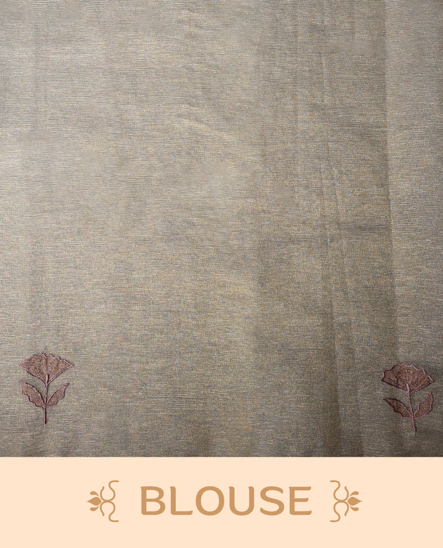 Beige gold colour organza designer saree featuring a subtle shimmer woven body with delicate green floral Soft mauve embroidery, scalloped thread detailing along the border and pallu paired with matching blouse.