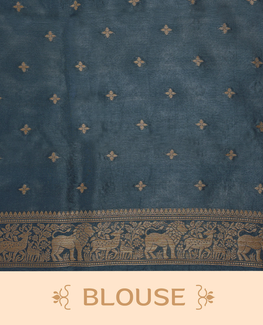German Blue semi-Banaras tussar georgette saree adorned with antique zari butta motifs on the body, accentuated by a beautifully crafted jungle-themed border, and paired with a matching blouse.