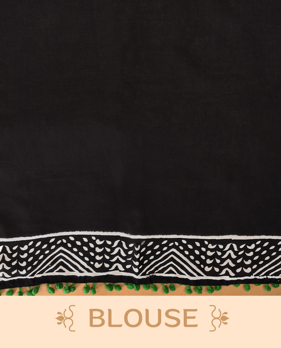 Black cotton saree features intricate white handblock prints, a beautifully detailed border with Green piping and Self Coloured Blouse