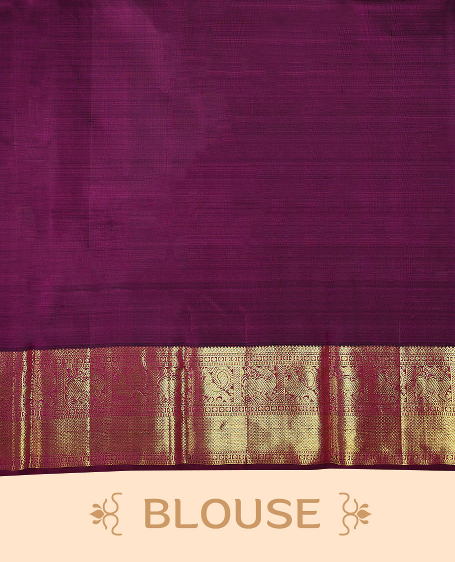 Blue Colour pure traditional Kancheepuram silk saree featuring antique zari peacock and chakkram motifs on the body, complemented by a traditional contrast coloured border and a matching contrast blouse.