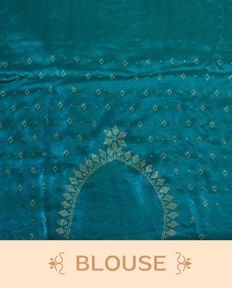 Teal colour chiffon designer saree, featuring delicate scattered stone detailing all over the body, highlighted with intricate stone work and a heavy geometric stone pattern along the border and pallu, paired with a matching embellished blouse.