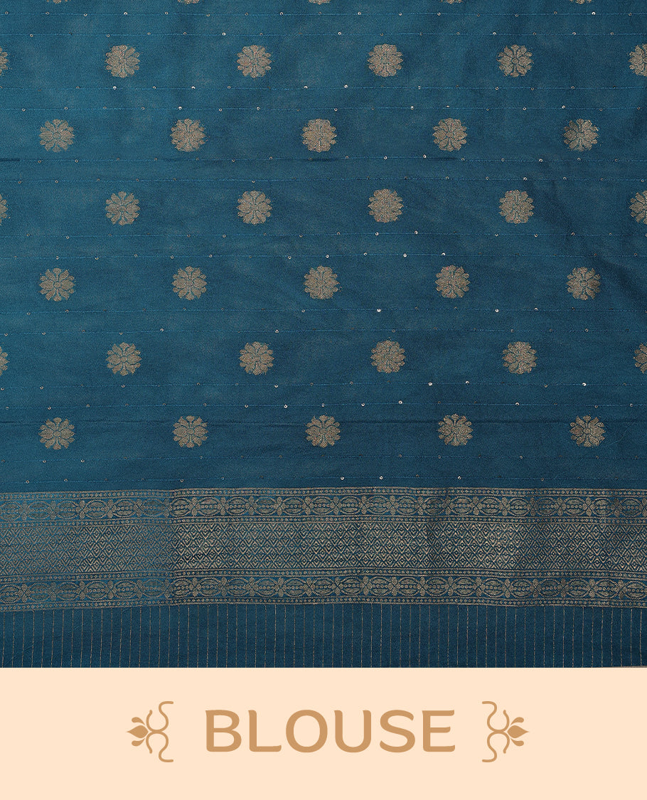 Blue coloured semi Banaras georgette saree featuring golden Zari checks with floral motifs on the body, complemented by a self coloured traditional border with floral kodi design and a matching blouse.