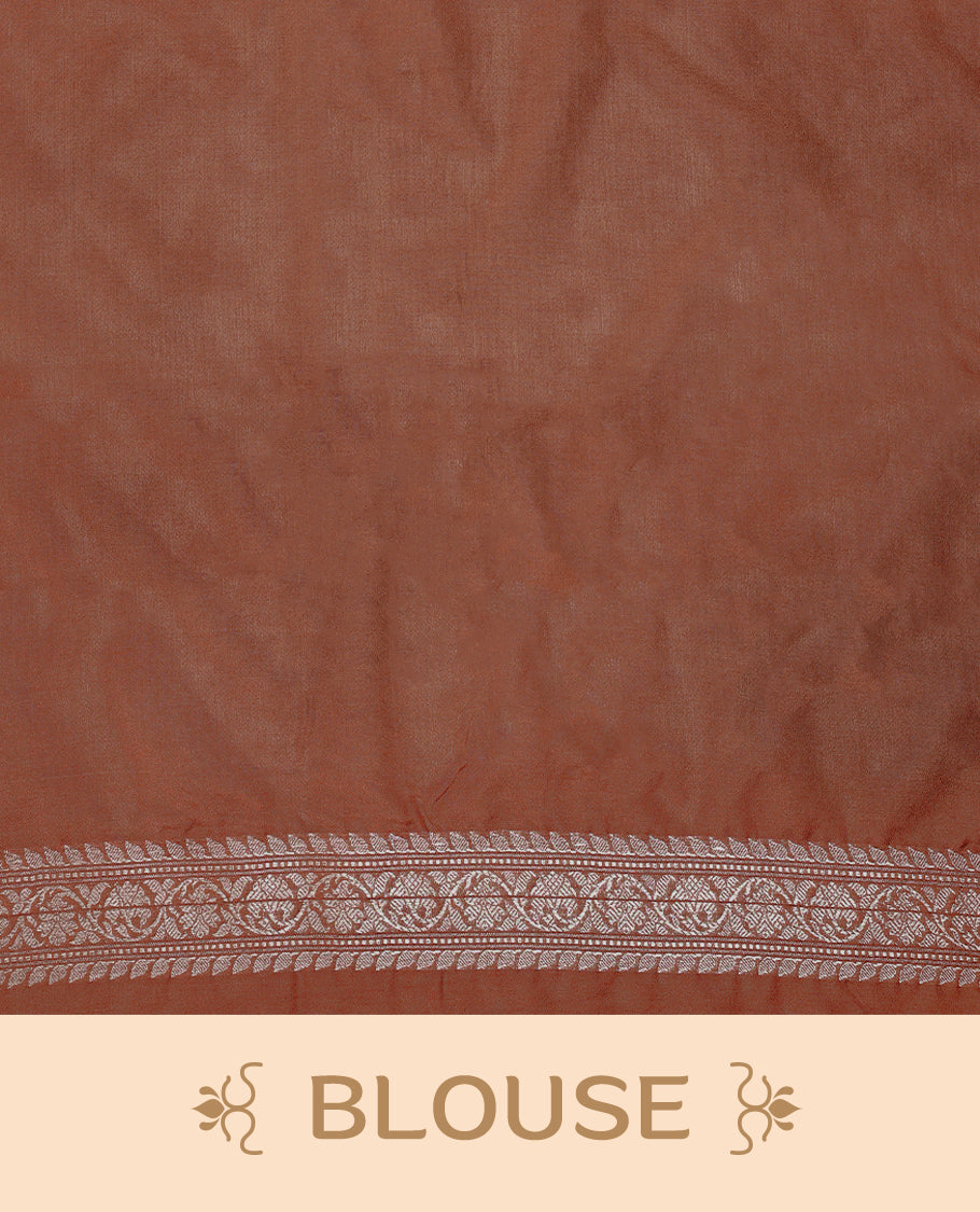 Light brown colour semi Banaras Katan saree featuring an antique silver zari jacquard body, complemented by a self colour traditional border with a floral kodi design, paired with a matching blouse