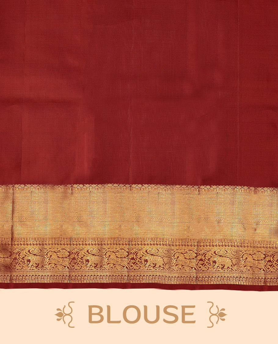 Deep red Colour pure traditional Kancheepuram silk saree adorned with intricately woven antique zari work on the body, complemented by Self colour traditional border featuring elephant, Horse, and Floral Kodi motifs, and paired with a matching blouse.