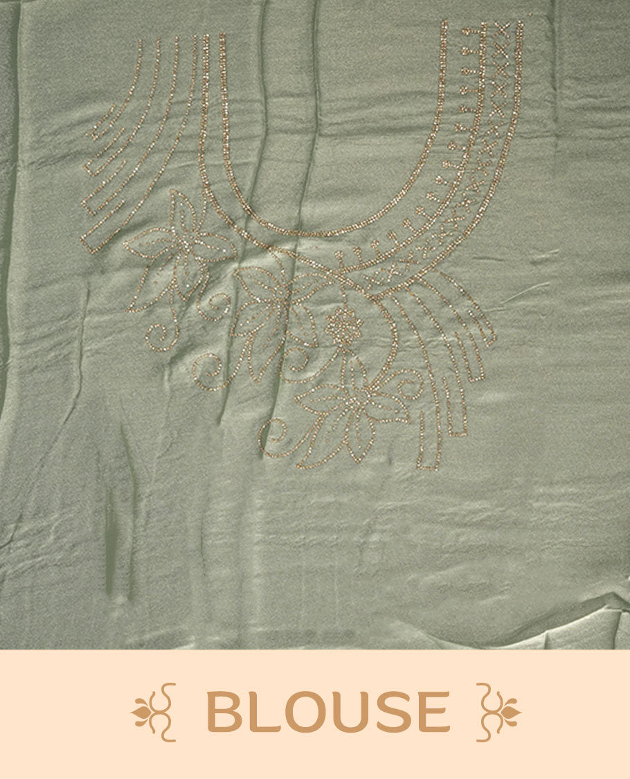 Pastel Green colour net shimmer fancy saree adorned with white stone buttas, paired with a delicate stone worked border and matching blouse.