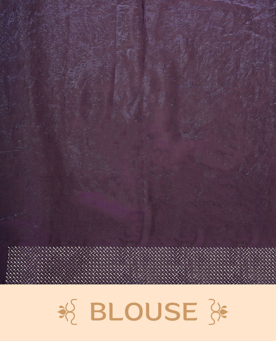 Dark purple colour chiffon designer saree, featuring dainty scattered stones on the body, enriched with dense stone work and a heavy metallic stone border and pallu, paired with a matching blouse.