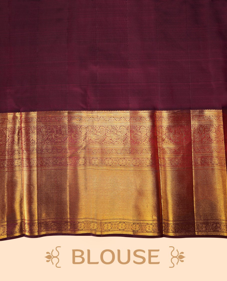 Off-white Colour traditional Kancheepuram silk saree adorned with antique zari floral motifs arranged in a symmetric grid on the body, featuring a contrasting border with floral, peacock, and chakram motifs, and paired with a matching blouse.