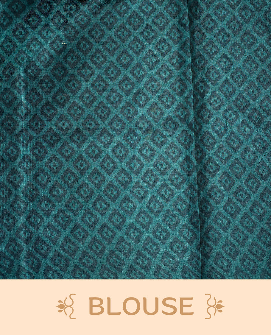 Charming teal, black, and cream printed saree featuring intricate geometric and floral designs, accentuated with a bold black border and tassel finish & paired with a matching blouse.
