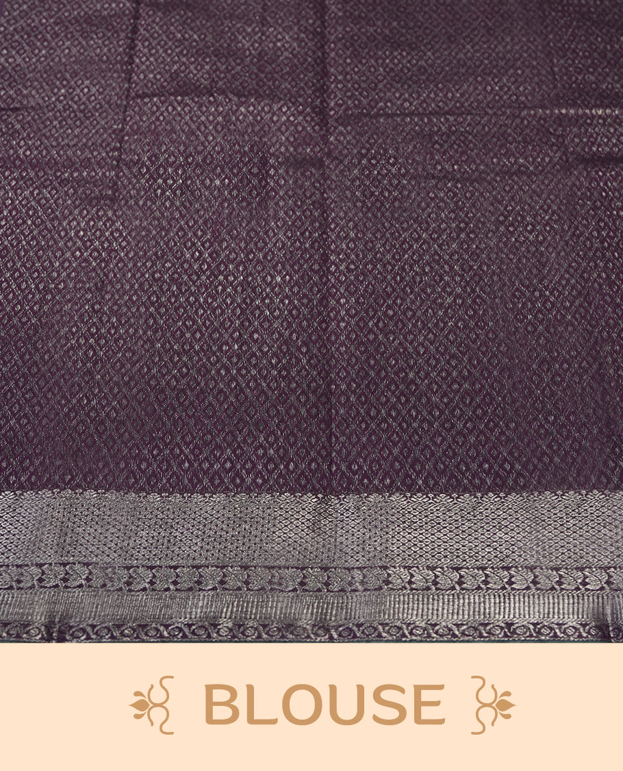 Grape colour silk cotton saree with shimmering silver zari border and intricately woven pallu, blending elegance and tradition. Paired with a matching blouse, perfect for festive celebrations and special occasions.