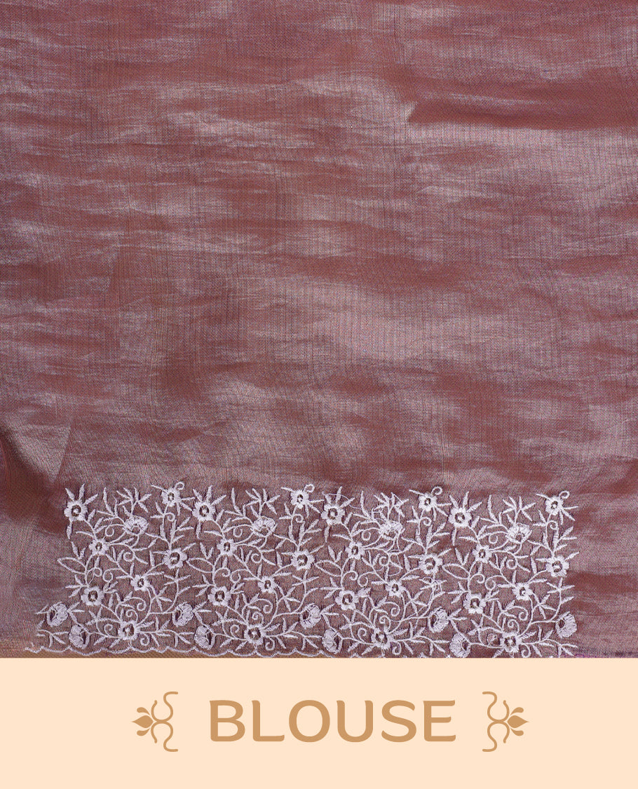 Pink colour net organza designer saree featuring a subtle self patterned body and an intricately scalloped floral thread embroidered border all around, complemented by a coordinating embroidered pallu and paired with a matching blouse.