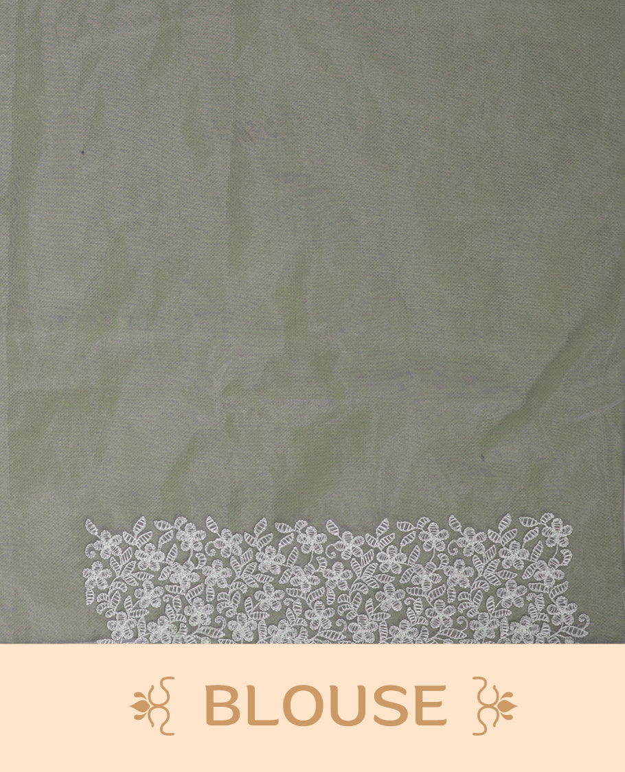 Pastel green colour organza designer saree featuring a subtle self patterned body and an intricately scalloped floral thread embroidered border all around, complemented by a coordinating embroidered pallu and paired with a matching blouse.