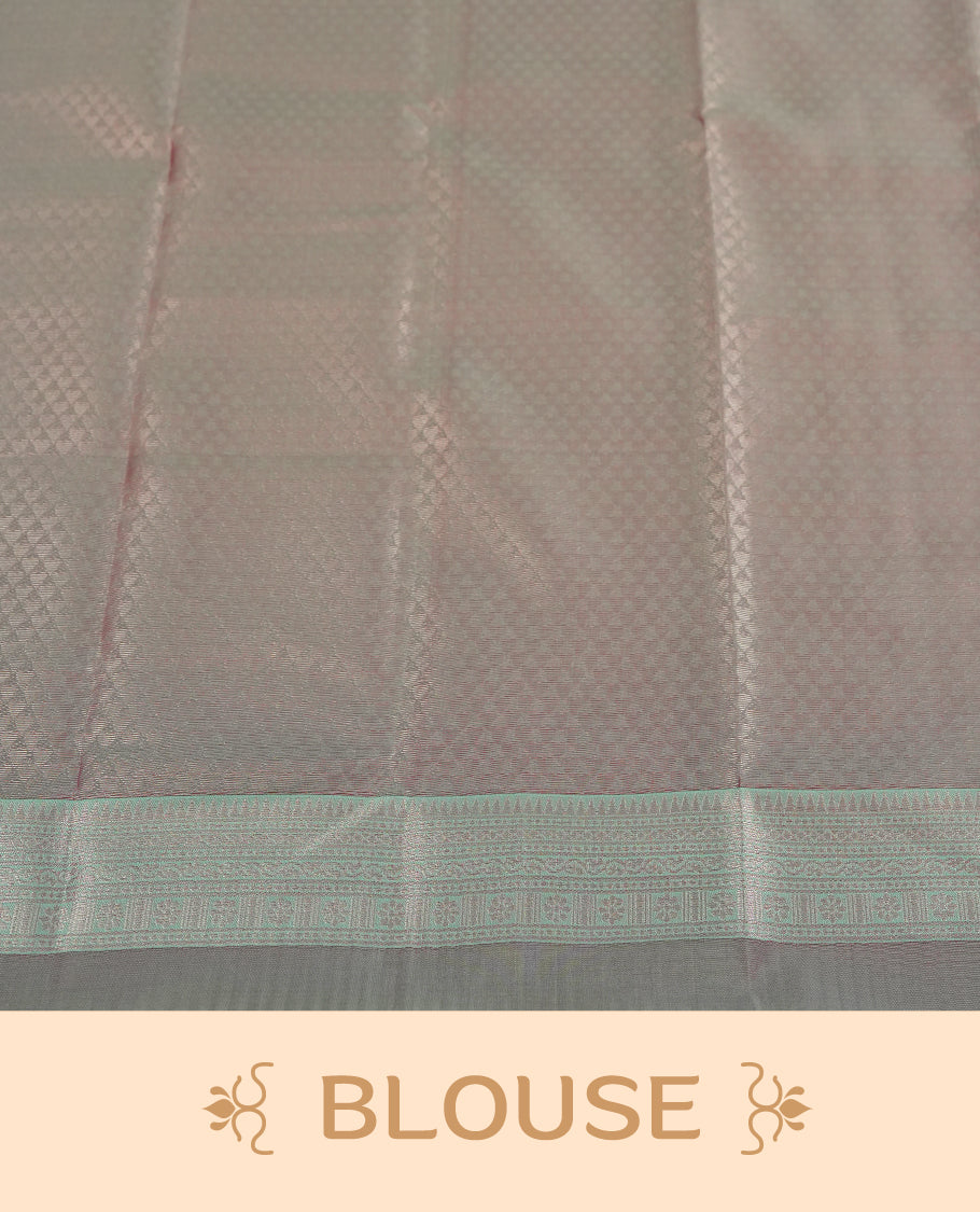 Light pink colour semi silk saree adorned with silver zari designs on the body, complemented by a contrasting light green and silver border and pallu, and paired with a matching blouse piece