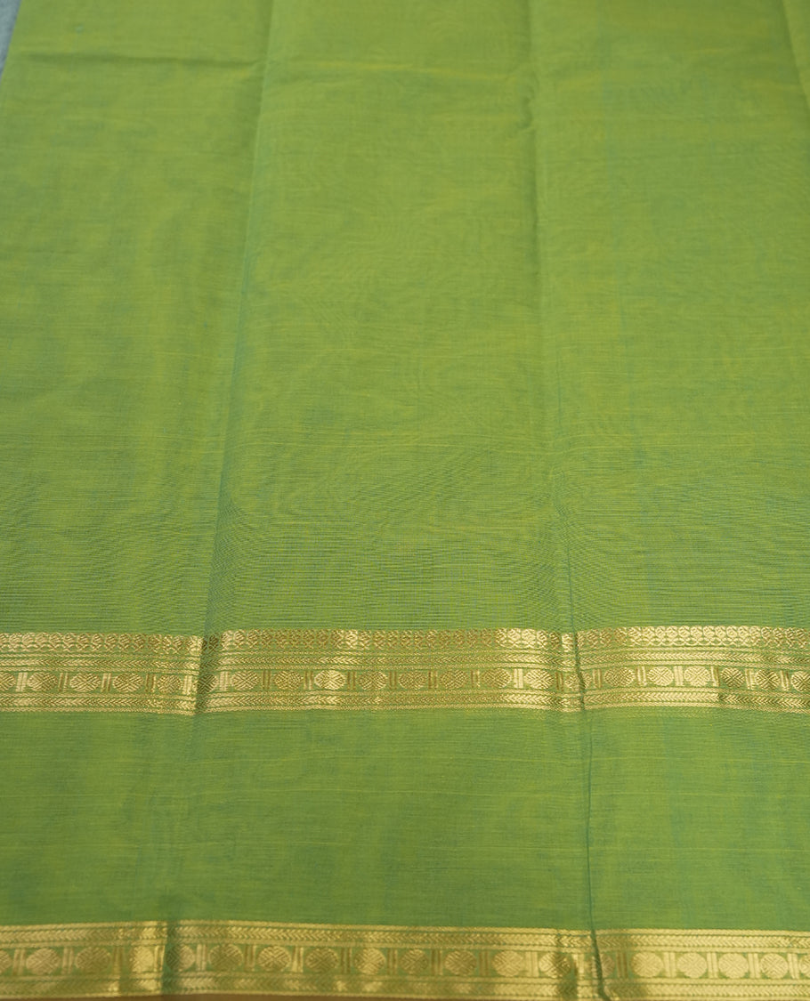 Fern Green colour Pure Kanchi cotton saree featuring delicate golden buttas and a rich zari border with intricate motifs & Paired with a matching blouse, it exudes timeless elegance, perfect for festive and traditional occasions.