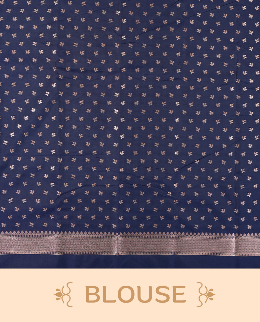 Dark blue colour semi silk saree adorned with elegant floral motifs on the body, complemented by a shimmering golden zari-woven pallu and border, and paired with a matching blouse