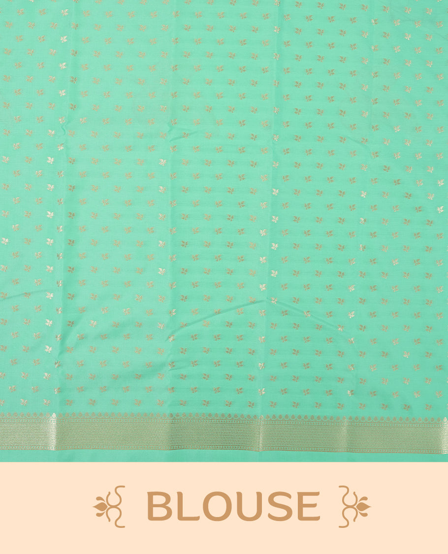 Mint green colour semi silk saree adorned with elegant floral motifs on the body, complemented by a shimmering golden zari-woven pallu and border, and paired with a matching blouse