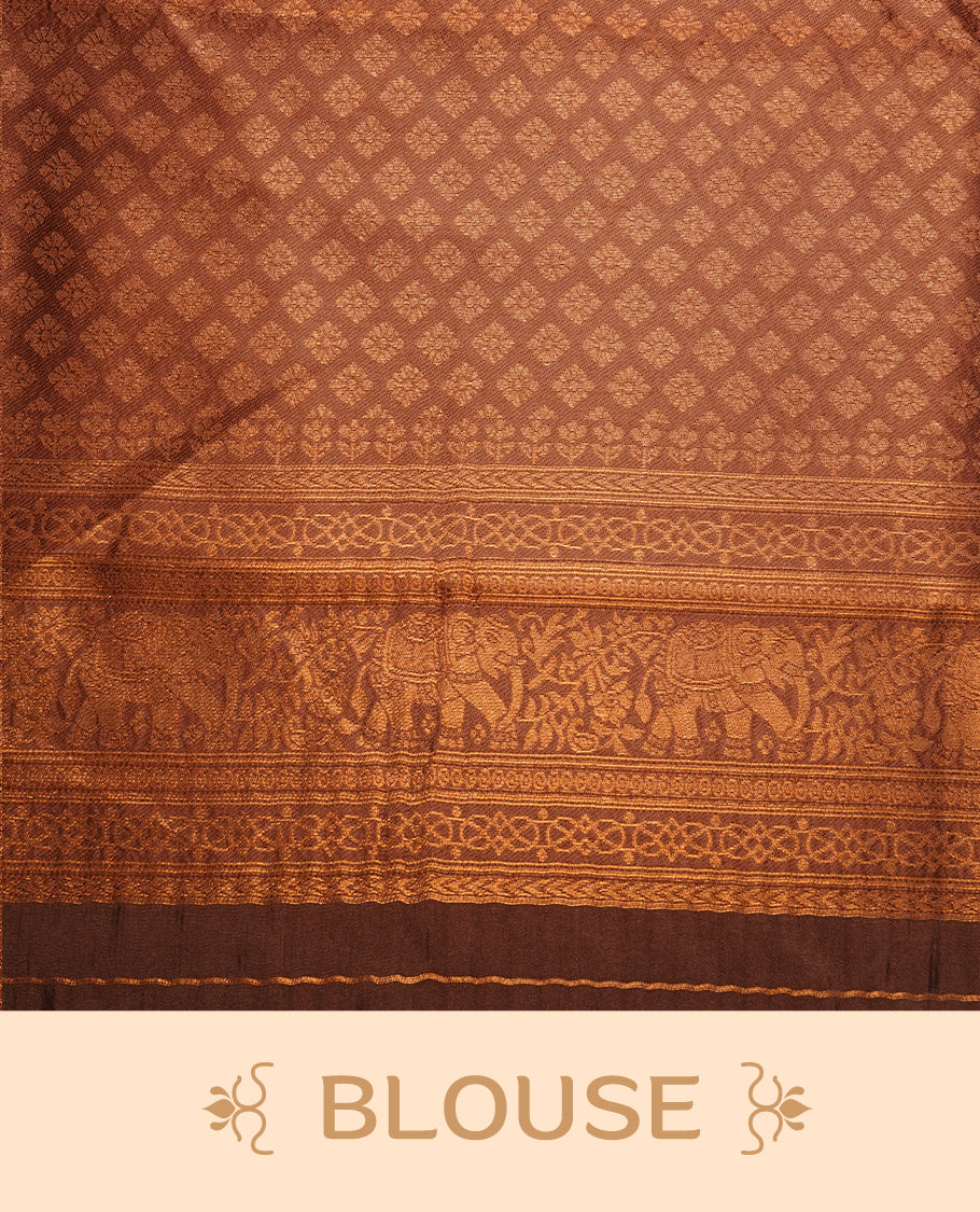 Burnt orange colour silk saree featuring gold zari check and motifs on body, complemented by contrast chocolate with traditional border, paired with matching blouse piece.