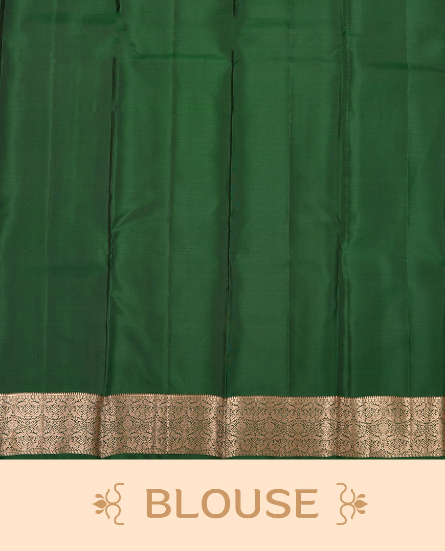 Dark Green colour Vasundhara silk saree adorned with all-over gold chakkaram & mayil motifs on the body, complemented by a gold tarditional border and paired with a matching blouse piece.