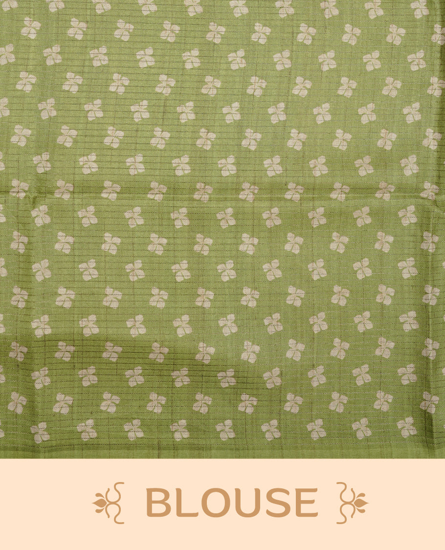 Leaf green colour semi tussar silk saree, featuring subtle hexagonal geometric patterns across the body, a textured pallu with fine detailing, and finished with a matching blouse.