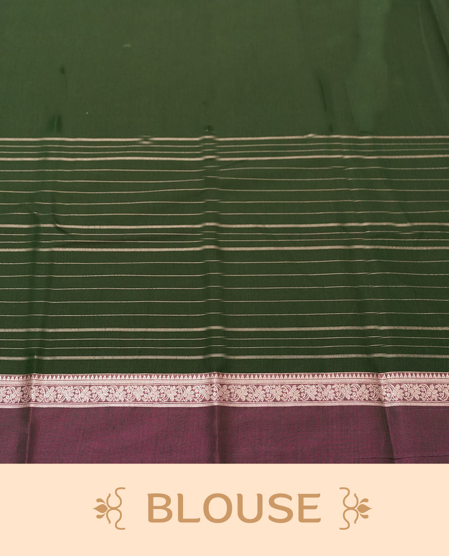 Green Colour silk cotton saree with scattered gold Warli animal motifs, gold horizontal stripes, ornate pink and gold zari border with floral patterns, gold zari pallu with diamond lattice and Warli dancer motifs, wine purple blouse.