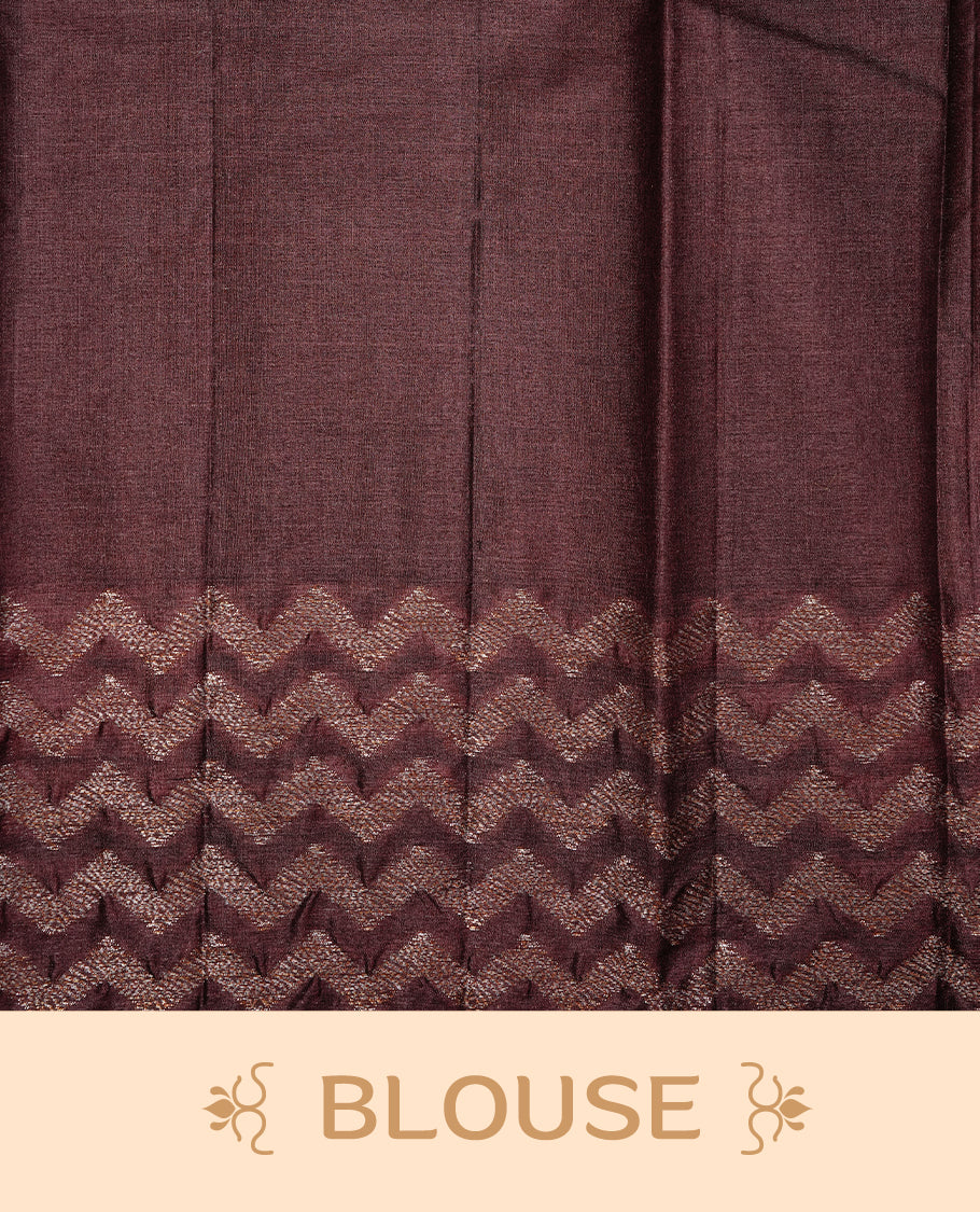 Cream Colour Tussar silk saree featuring Antique Zari motifs on body, Finished with contrast Chocolate colour Zigzag zari pattern border, paired with matching blouse piece.