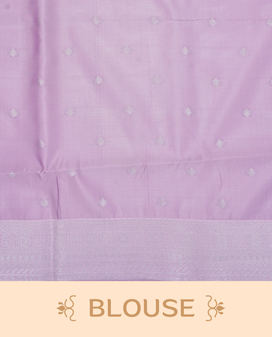 Green colour semi silk saree featuring Silver zari Floral pattern on body, complemented by contrast Purple colour with silver zari border, comes with matching blouse piece.
