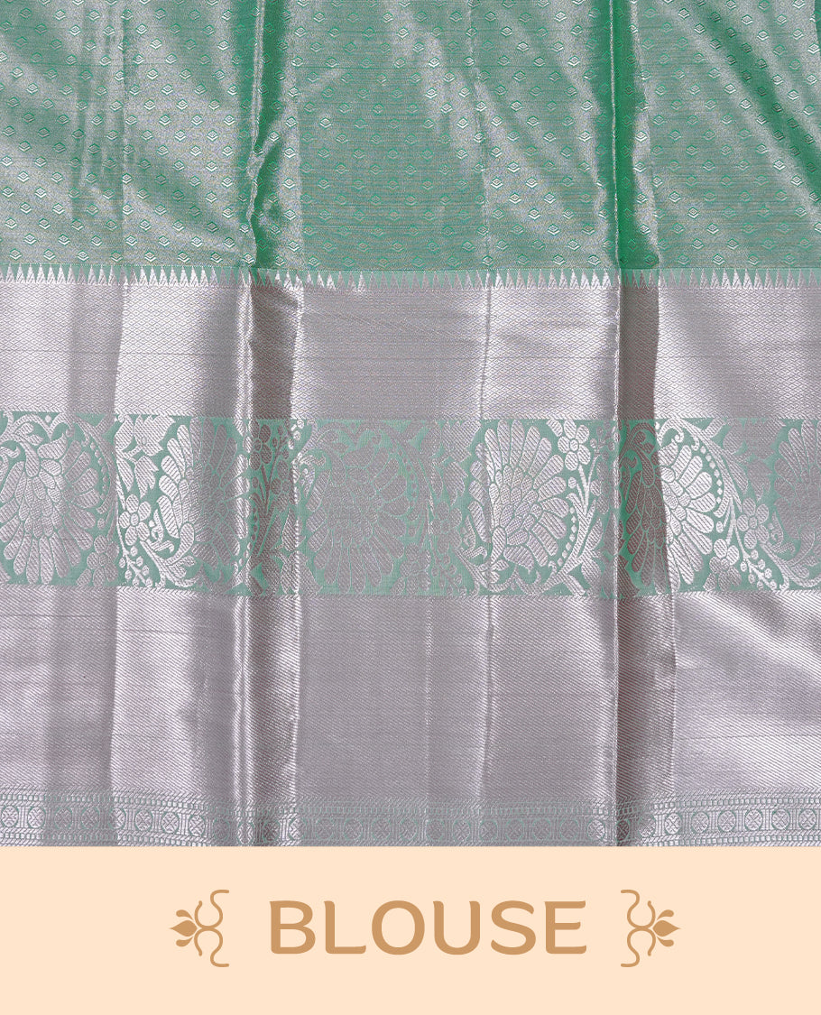 Light green colour tissue saree featuring rose gold zari floral kodi pattern on the body, highlighted by a self colour border with rose gold traditional zari, paired with a matching blouse piece.
