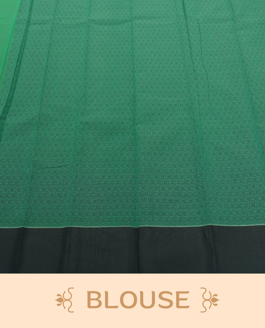 Emerald green colour silk cotton saree featuring subtle woven motifs throughout the body, enhanced by a striking grey contrast border and an intricately designed pallu with floral patterns & Comes with a matching blouse piece.