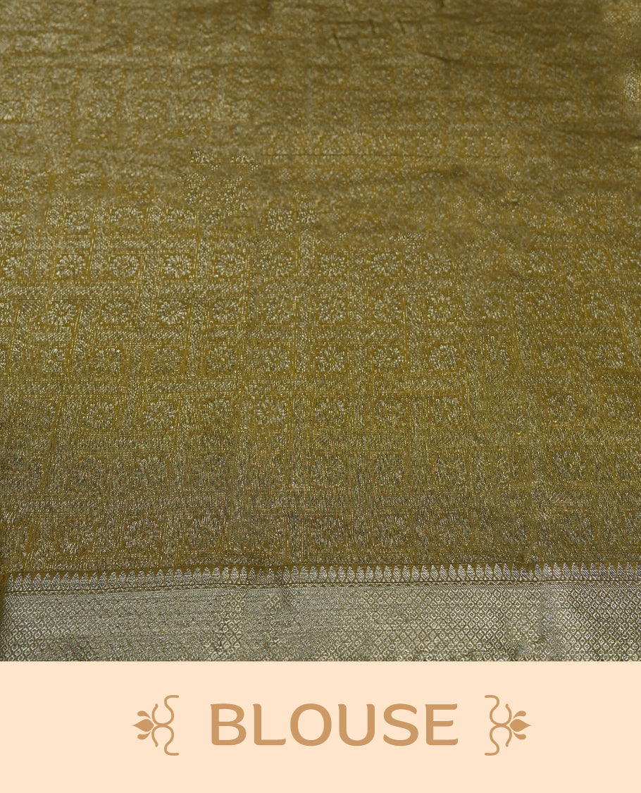 Bronze yellow colour silk cotton saree adorned with silver zari buttas and a rich zari border, complemented by a finely woven pallu & Paired with a matching blouse, perfect for festive gatherings and traditional occasions.