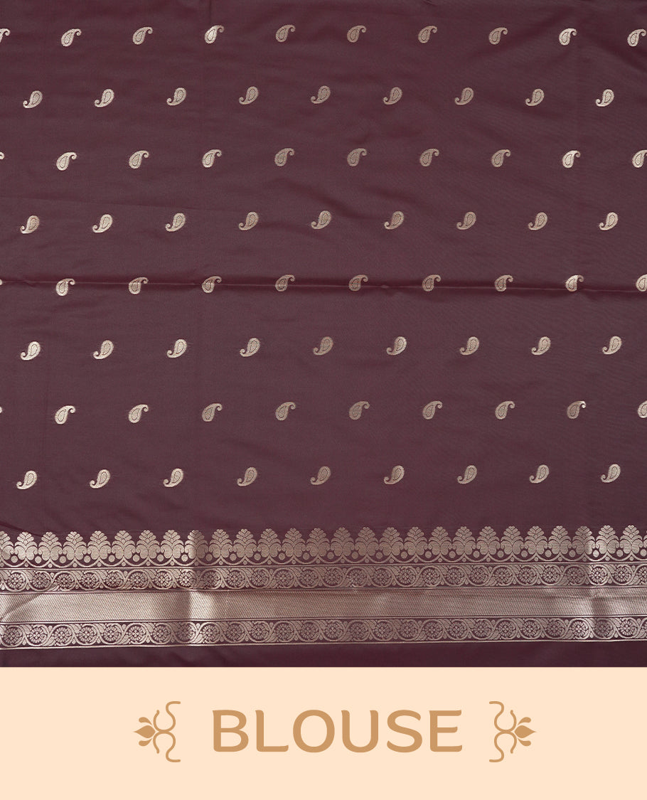 Dark Brown colour semi soft silk saree featuring an all-over woven leaf pattern in gold colour, finished with a matching border adorned with detailed paisley and floral motifs, and a matching blouse piece.