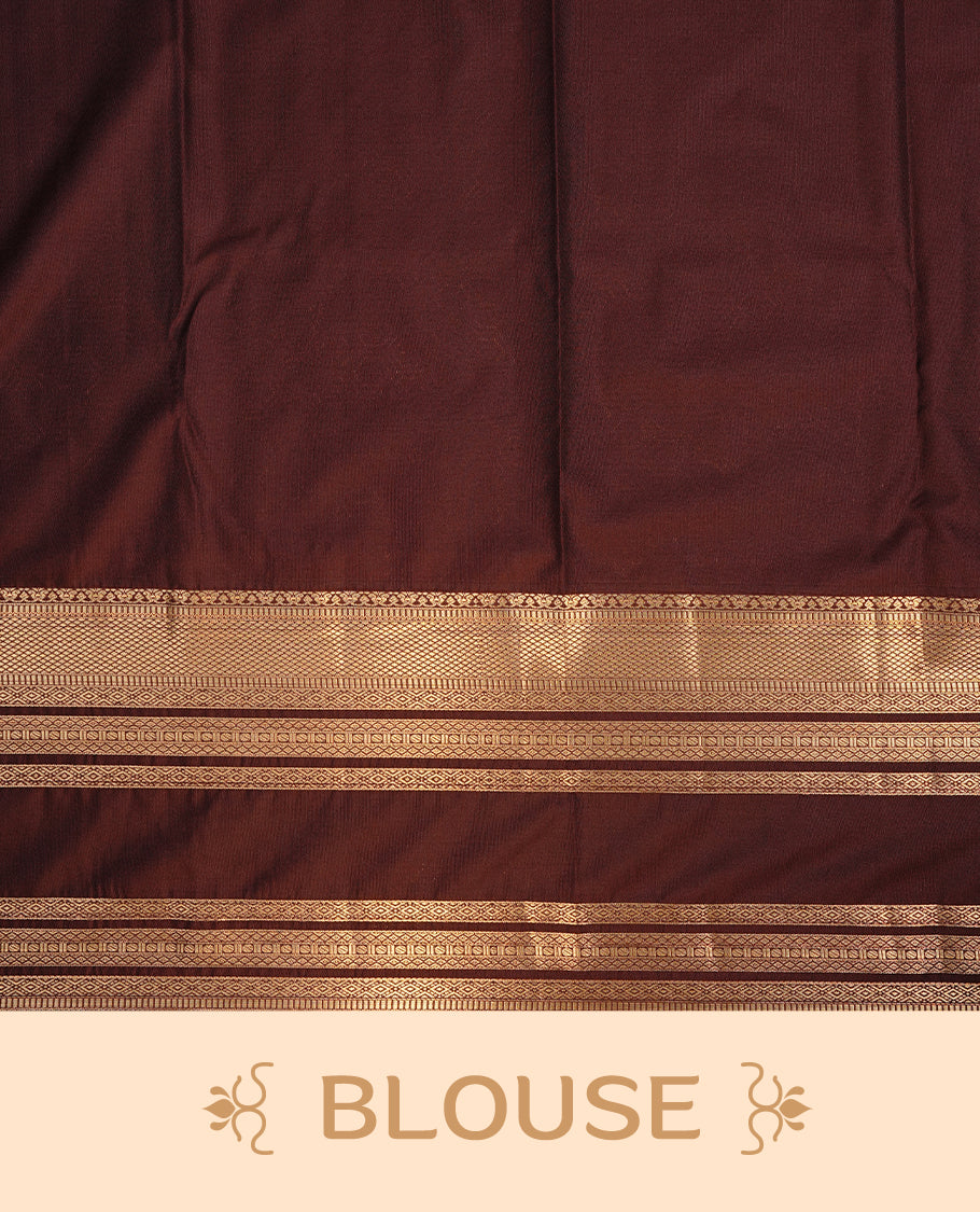 Orange colour semi wedding saree featuring gold zari Pattern on body, contrast chocolate colour with traditional border, paired with matching blouse piece.