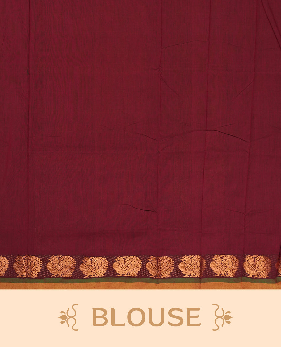 Parrot green colour Kalyani Cotton saree in deep maroon with golden peacock motifs, paired with a contrasting maroon border featuring intricate peacock zari work & Comes with a matching blouse piece.