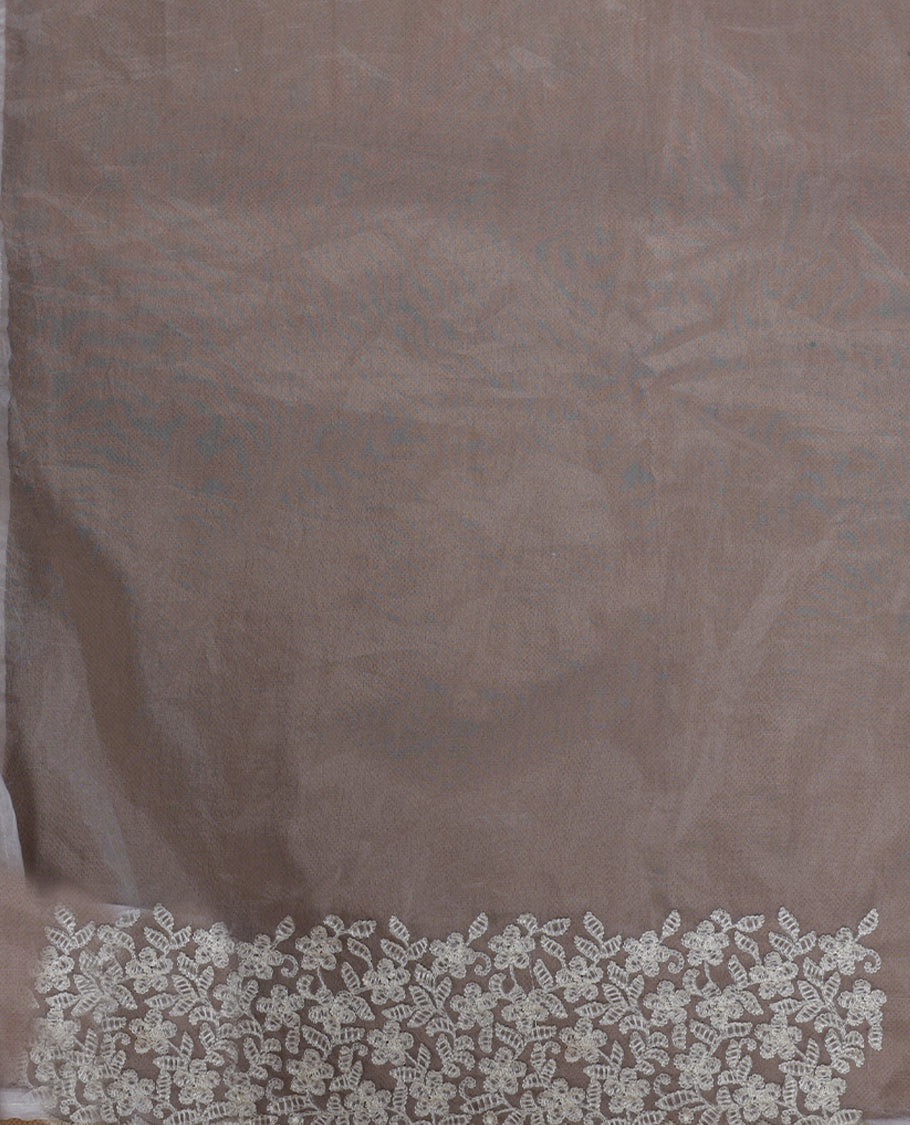 Light yellow colour organza designer saree featuring a subtle self patterned body and an intricately scalloped floral thread embroidered border all around, complemented by a coordinating embroidered pallu and paired with a matching blouse.