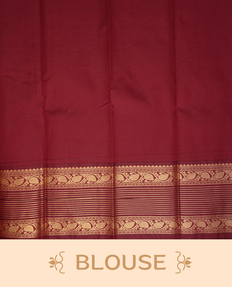 Green coloured soft silk saree featuring gold zari stripes and motifs across the body, enhanced with a contrast Maroon border and pallu, paired with a matching contrast blouse piece.