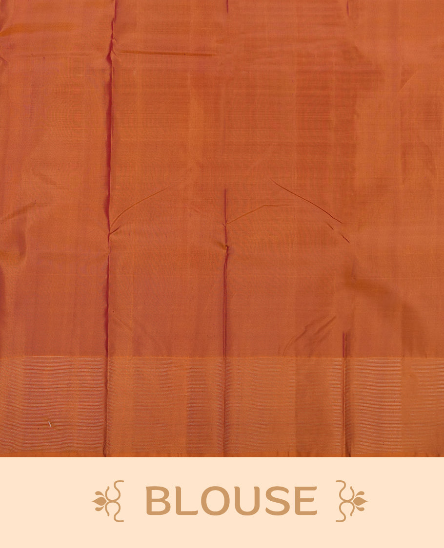 Burnt orange colour Vasundhara silk saree adorned with all-over purple zigzag motifs on the body, complemented by a self colour with gold line pattern border and paired with a matching blouse piece.