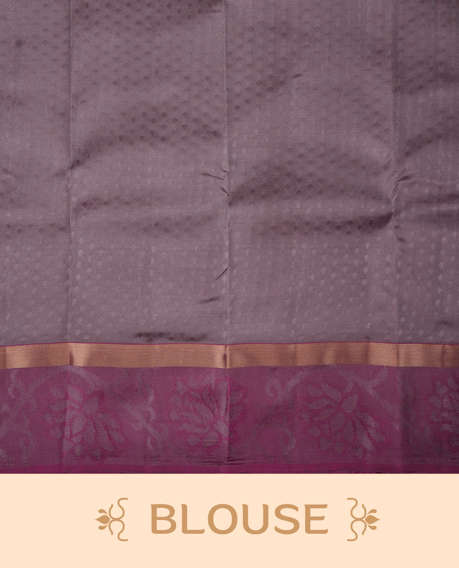Dusty lavender colour soft silk saree featuring gold zari motifs on the body, complemented by a contrast magenta traditional zari floral kodi border and pallu, paired with a matching blouse piece.