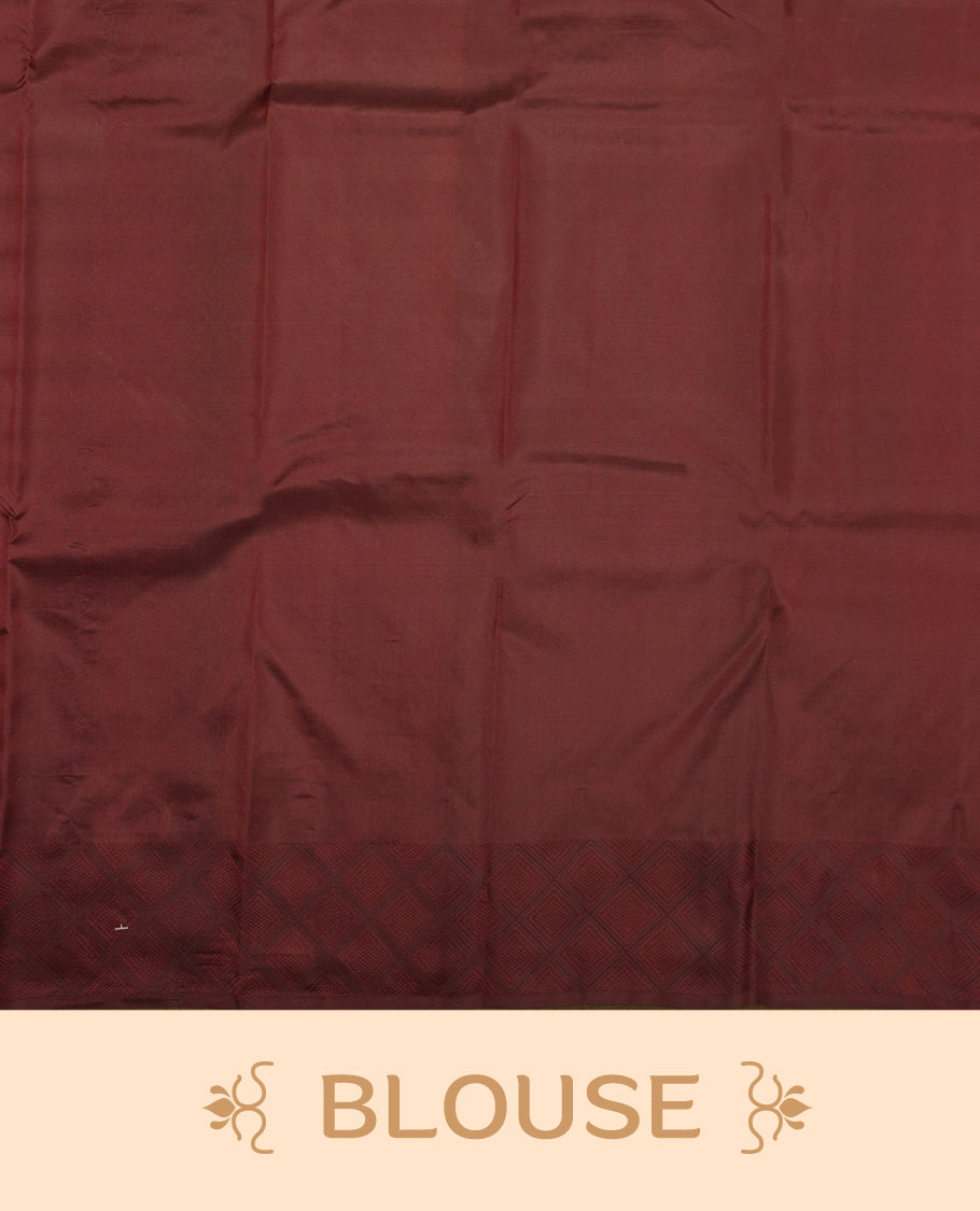 Dark maroon colour Vasundhara silk saree adorned with all-over tiny gold square motifs on the body, complemented by a self colour zari border and paired with a matching blouse piece.