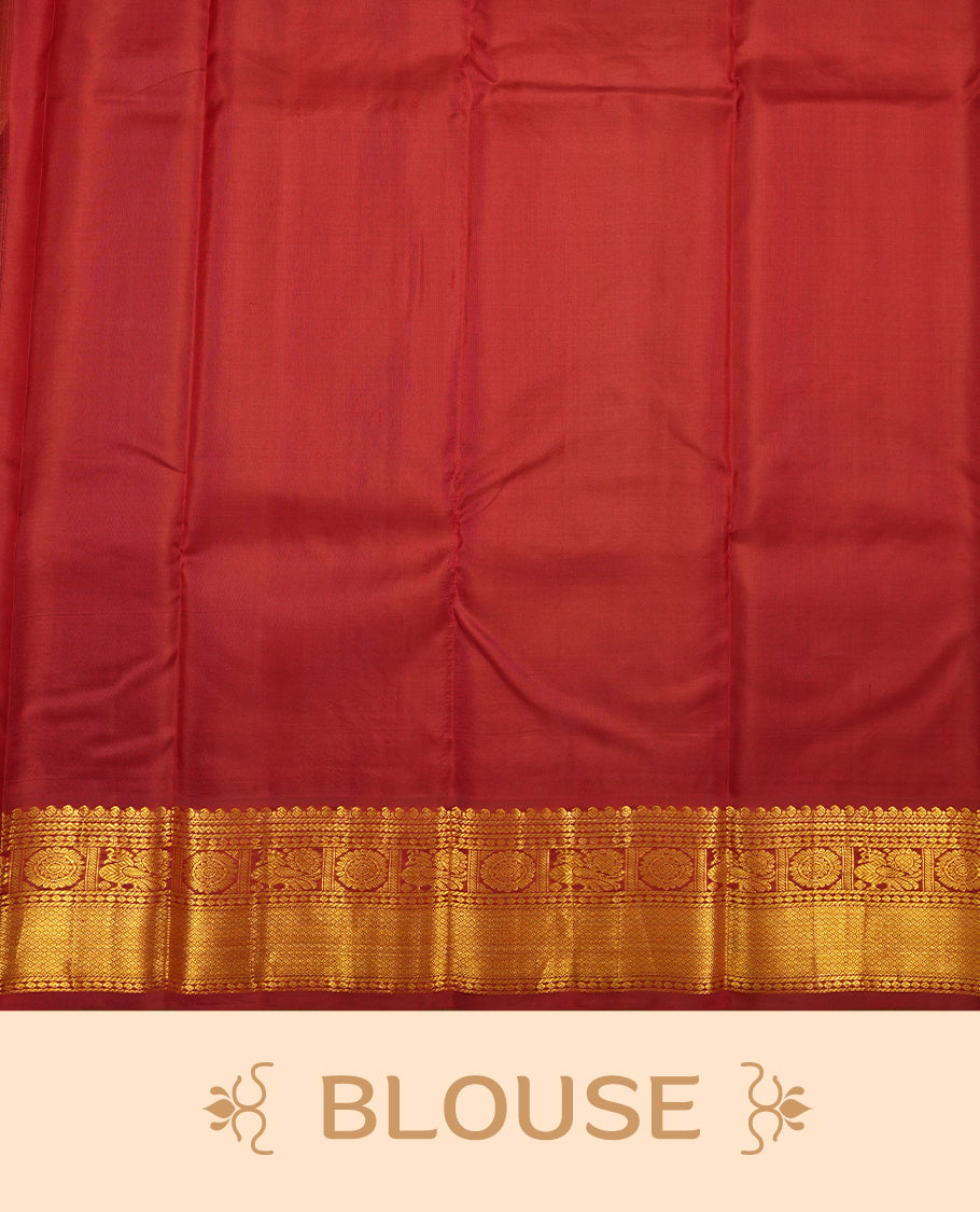 Cream colour Vasundhara silk saree adorned with all-over gold chakkaram & mayil motifs on the body, complemented by a contrast maroon gold tarditional border and paired with a matching blouse piece.