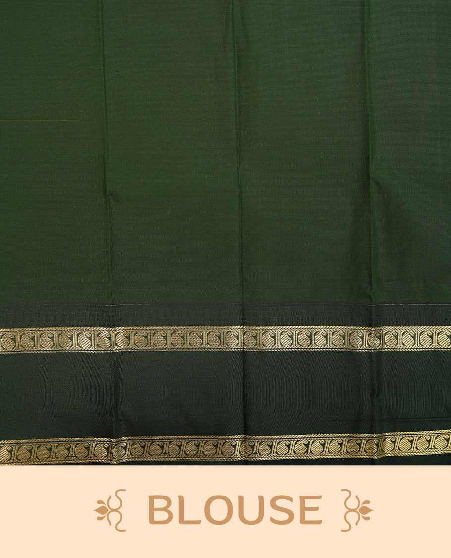 Mustard coloured soft silk saree featuring gold zari stripes and motifs across the body, enhanced with a contrast Dark green border and pallu, paired with a matching contrast blouse piece.