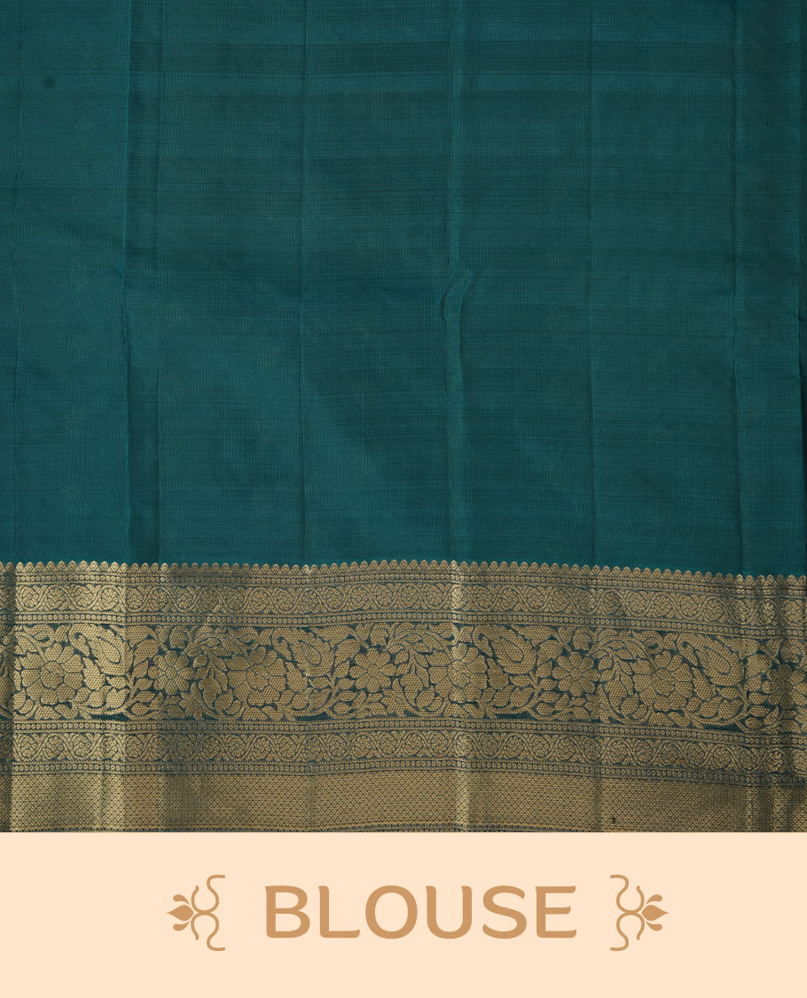 Purple colour soft silk saree featuring gold zari floral motifs on the body, complemented by a contrast green traditional zari floral kodi border and pallu, paired with a matching blouse piece.