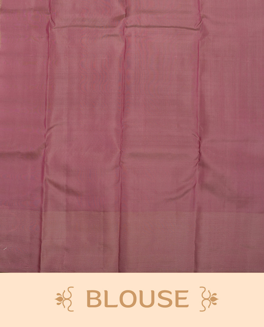 Dusty purple colour Vasundhara silk saree adorned with all-over zigzag motifs on the body, complemented by a self colour with gold line pattern border and paired with a matching blouse piece.