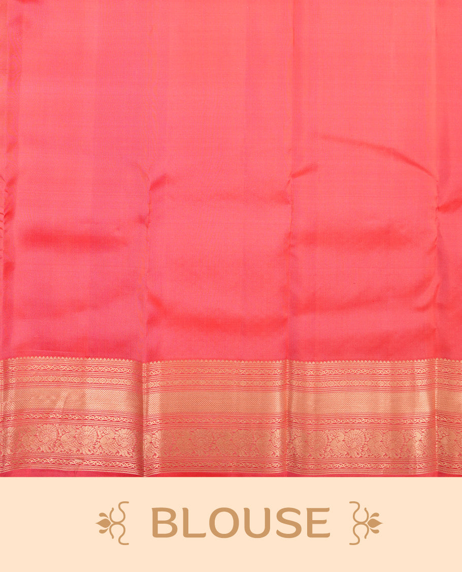 Reddish peach colour Vasundhara silk saree featuring Gold zari motifs across the body, finished with a self‑coloured traditional border and a coordinating blouse.