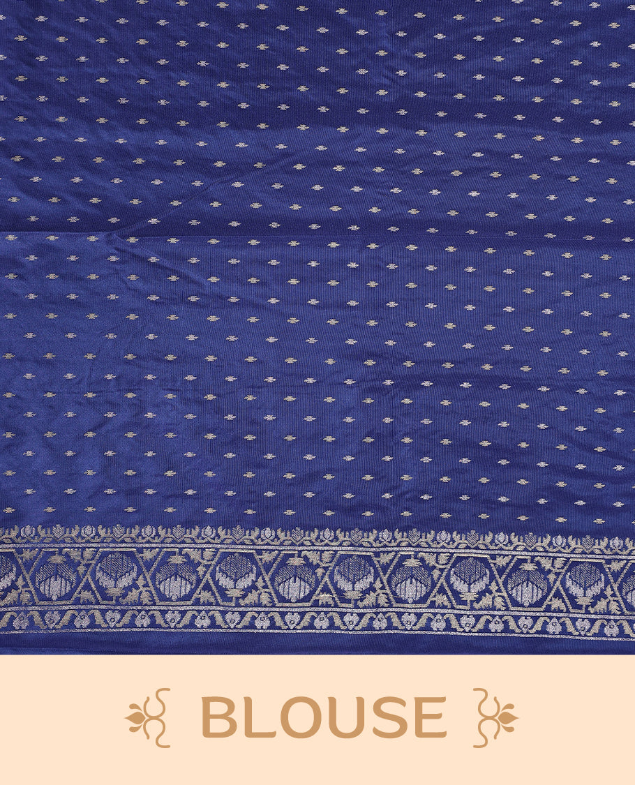 Blue Banaras soft silk saree with silver zari floral vines on the body, intricately woven border, and a grand pallu with bold paisley motifs, Comes with a matching blouse & perfect for elegant occasions.