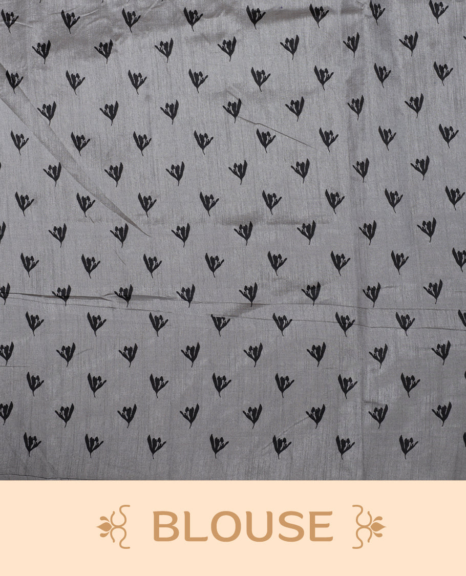 Pastel Grey colour Semi tussar silk saree adorned with black floral prints on the body and an elegant pallu & Comes with a matching blouse piece for a classy look.