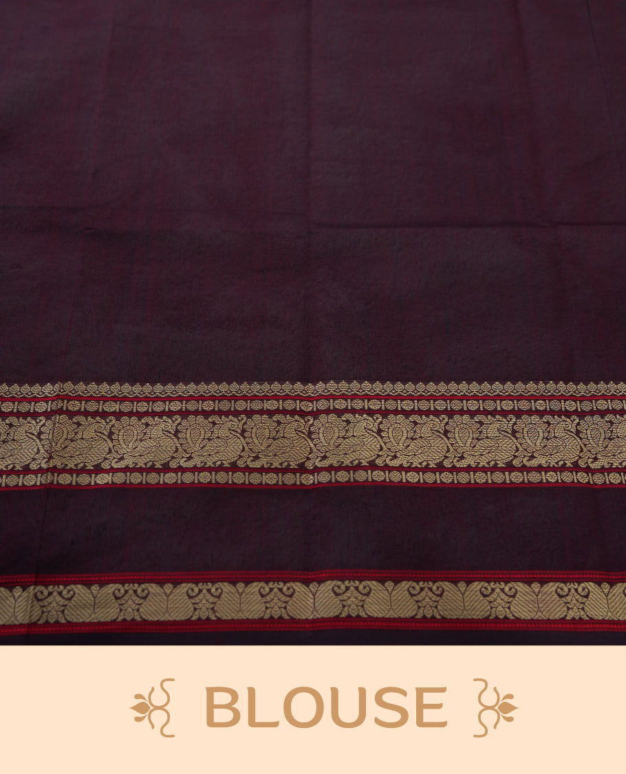Deep maroon colour pure Kanchi cotton saree adorned with subtle beige zari motifs across the body, The intricate zari woven border adds a touch of tradition & Includes a matching blouse piece for a complete look.