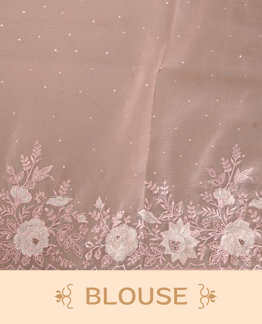 Pinkish beige colour organza saree featuring thread with cut beats & sequins floral pattern on body, highlighting scalp border, paired with matching blouse piece.