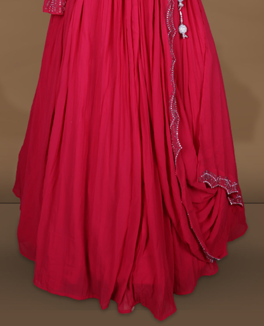 Rani pink colour stitched gown set with square neckline, attached pleated flare, and one‑side draped dupatta highlighted with heavy silver sequin and mirror work border and sleeve.