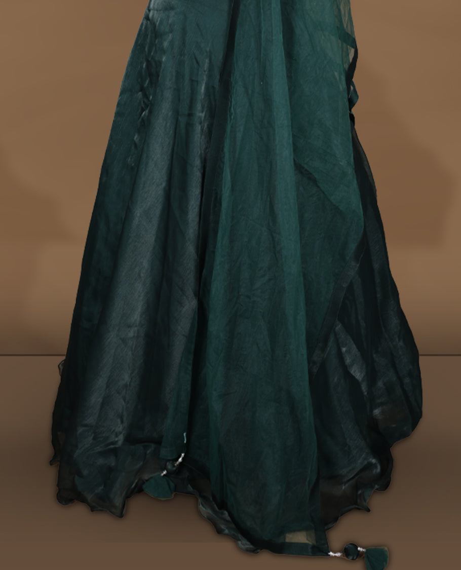 Emerald green colour Gown with stitched sleeveless blouse featuring embellished neckline and waist detailing, paired with a matching stitched flared lehenga and sheer dupatta.